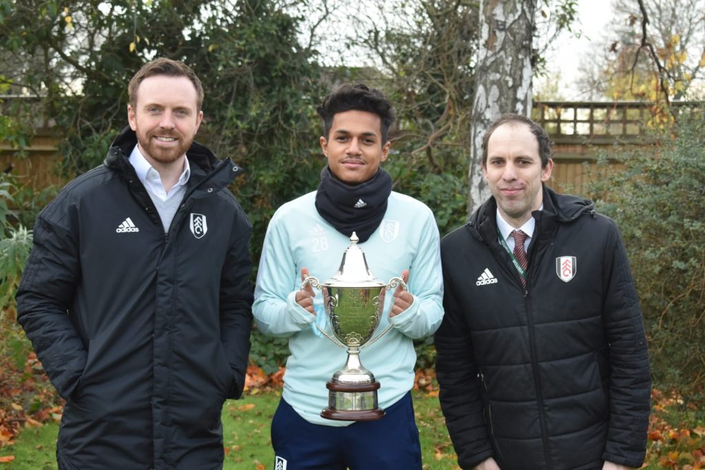 Trust member Dan Crawford Academy Director Mike Cave & Fabio Carvalho standing together with trophy