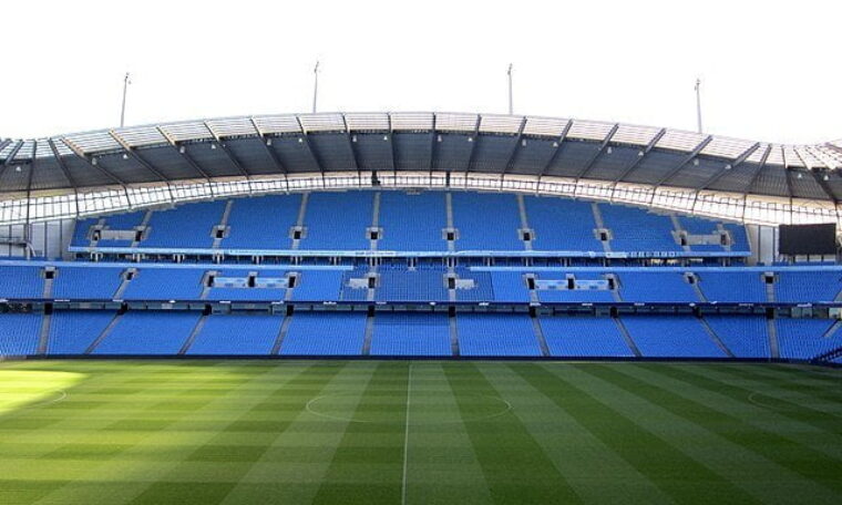 Portrait image of pitch and stand at Etihad Stadium, Manchester