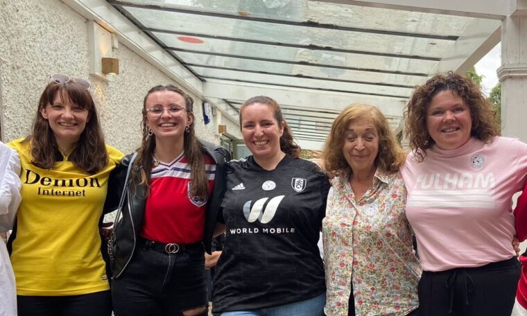 Pan-shot of faces of co-founders of the Fulham Lillies supporter group, wearing various Fulham shirts